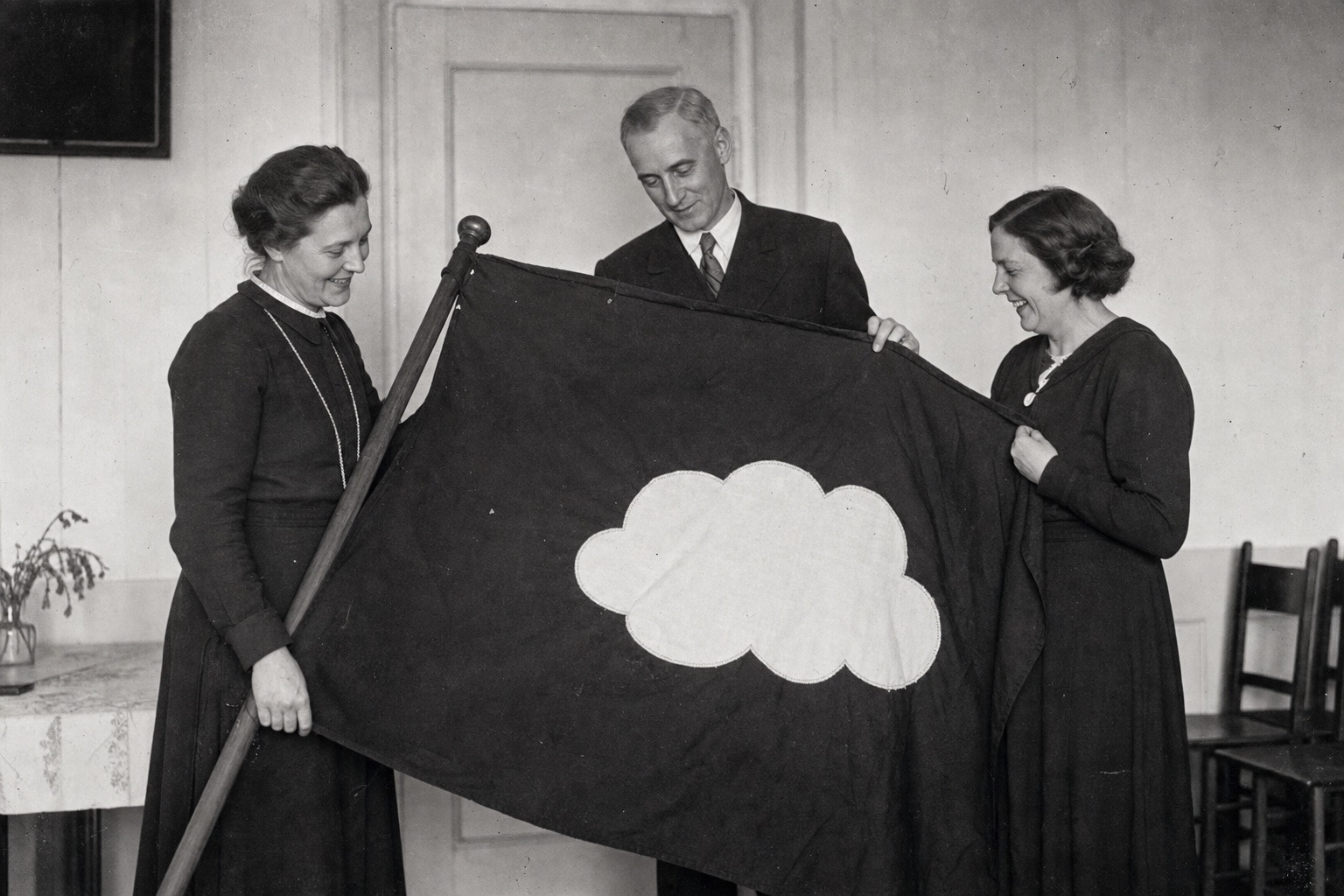 Anne-Marie Nebelgaard og medlemmer viser det håndsyede skybanner
